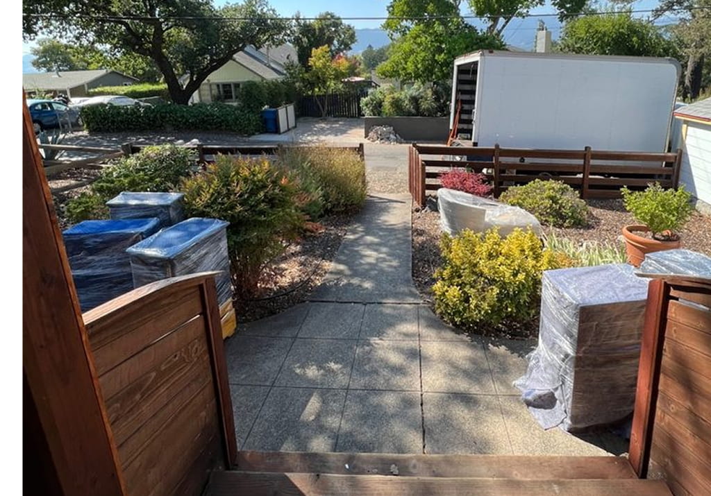 Movers helping a homeowner sort and downsize belongings