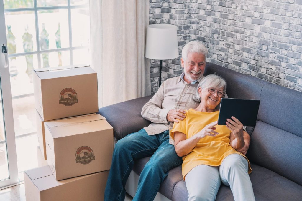 Movers helping a senior couple pack belongings for a move